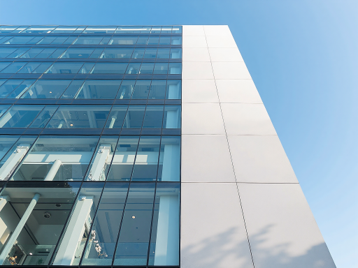 Modern office building exterior with glass facade and corporate signage, professional business environment